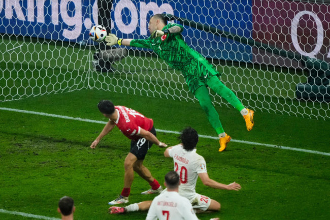 turkeys-goalkeeper-mert-gunok-saves-the-ball-during-a-round-of-sixteen-match-between-austria-and-turkey-at-the-euro-2024-soccer-tournament-in-leipzig-germany-tuesday-july-2-2024-ap-photoebrahi