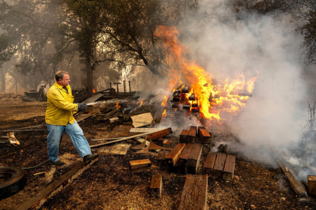 shane-lawson-an-off-duty-firefighter-works-to-extinguish-flames-from-the-grubbs-fire-in-the-palermo-community-of-butte-county-calif-on-wednesday-july-3-2024-firefighters-stopped-the-fire-at-ar