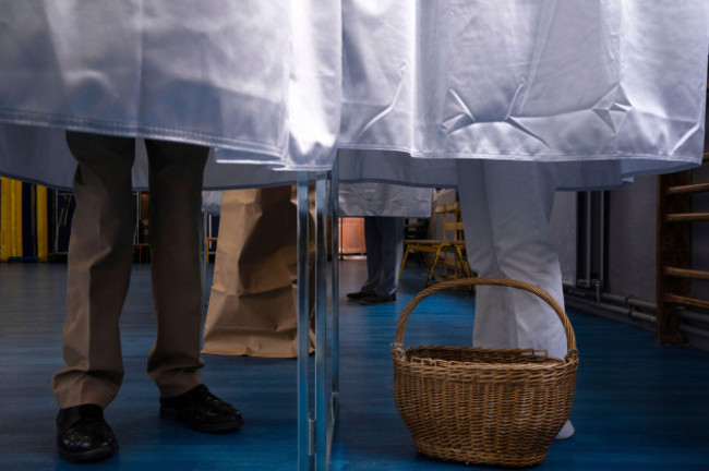 voters-stand-in-the-polling-booth-during-the-second-round-of-the-legislative-elections-sunday-july-7-2024-in-paris-france-votes-sunday-in-pivotal-runoff-elections-that-could-hand-a-historic-victor