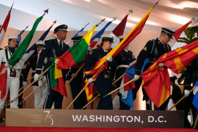 members-of-the-military-carry-flags-of-nations-before-an-event-commemorating-the-75th-anniversary-of-nato-at-the-andrew-w-mellon-auditorium-on-the-sidelines-of-the-nato-summit-in-washington-tuesday