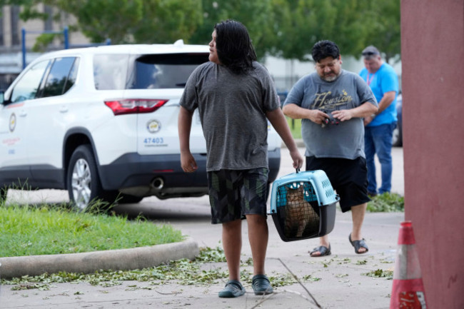 residents-arrive-at-a-cooling-station-in-houston-tuesday-july-9-2024-after-hurricane-beryl-slammed-into-texas-knocking-out-power-to-nearly-3-million-homes-and-businesses-it-moved-east-and-weakene