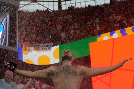 an-englands-fan-dances-in-the-rain-as-the-semifinal-between-netherlands-and-england-at-the-euro-2024-soccer-tournament-in-dortmund-germany-wednesday-july-10-2024-ap-photothanassis-stavrakis