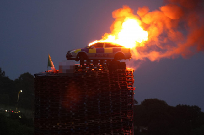 editors-note-poster-blurred-by-pa-picture-desk-a-mock-police-car-is-set-alight-on-top-of-a-bonfire-in-moygashel-near-dungannon-co-tyrone-the-burning-of-loyalist-bonfires-is-part-of-the-traditional