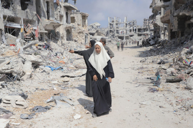 gaza-11th-july-2024-people-are-seen-on-a-street-with-destroyed-buildings-in-the-shujaiya-neighborhood-in-east-of-gaza-city-on-july-11-2024-more-than-60-bodies-were-recovered-from-the-rubble-in-t