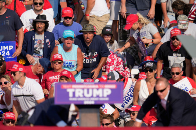 the-crowd-reacts-as-republican-presidential-candidate-former-president-donald-trump-is-surrounded-by-u-s-secret-service-agents-at-a-campaign-event-in-butler-pa-on-saturday-july-13-2024-ap-phot