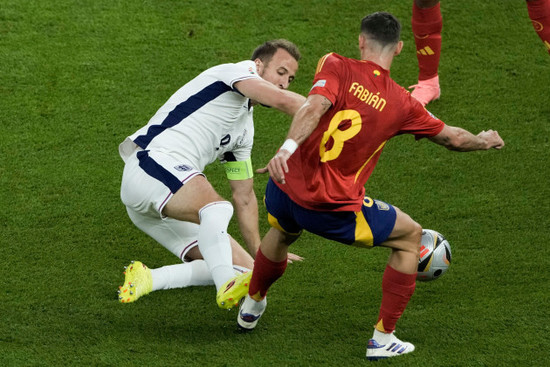 englands-harry-kane-left-and-spains-fabian-ruiz-battle-for-the-ball-during-the-final-match-at-the-euro-2024-soccer-tournament-in-berlin-germany-sunday-july-14-2024-ap-photothanassis-stavrak