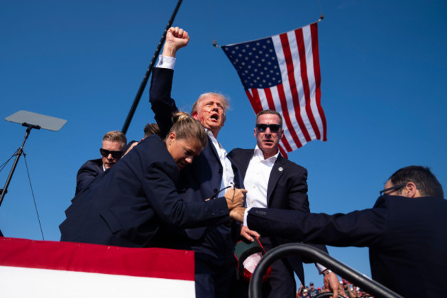 republican-presidential-candidate-former-president-donald-trump-is-surrounded-by-u-s-secret-service-agents-at-a-campaign-rally-saturday-july-13-2024-in-butler-pa-ap-photoevan-vucci
