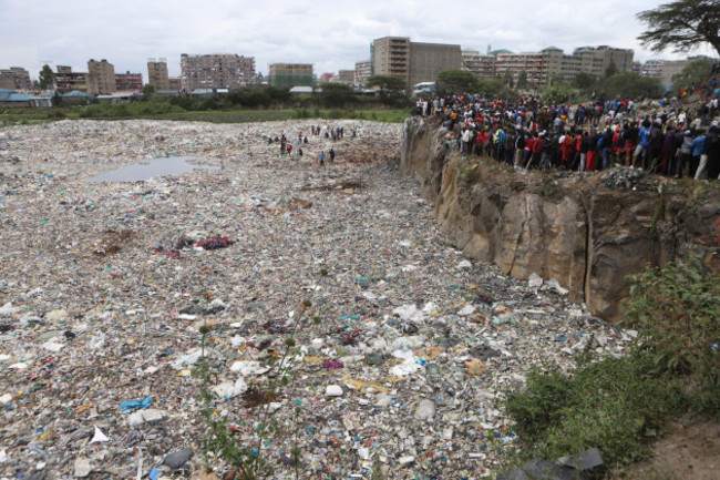 people-watch-from-the-edge-of-a-quarry-where-human-remains-were-found-in-mukuru-kwa-njenga-area-in-nairobi-kenya-saturday-july-13-2024-police-in-kenya-said-monday-they-have-arrested-the-main-susp