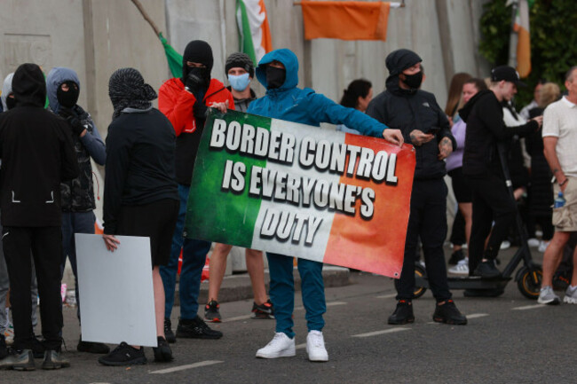 protesters-gather-at-the-former-crown-paints-factory-in-coolock-north-dublin-following-plans-to-redevelop-the-disused-warehouse-to-house-asylum-seekers-picture-date-tuesday-july-16-2024