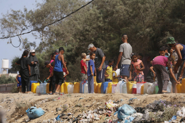 palestinians-are-lining-up-to-fill-their-containers-with-water-on-a-street-next-to-tents-in-al-zawayda-in-the-central-gaza-palestinians-are-lining-up-to-fill-their-containers-with-water-on-a-street-n