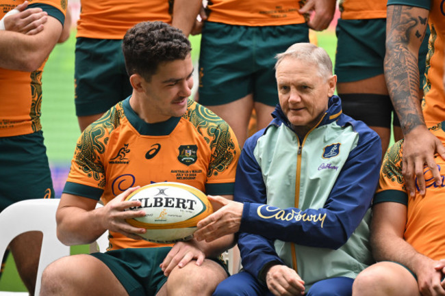 melbourne-australia-12th-july-2024-josh-nasser-of-the-wallabies-left-is-handed-a-ball-from-wallabies-coach-joe-schmidt-during-a-team-photo-at-the-australian-wallabies-captains-run-at-aami-park-i