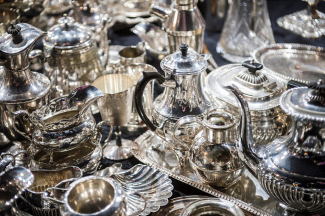 shiny-abstract-background-of-antique-silver-tableware-pieces-in-a-full-frame-luxury-jumble