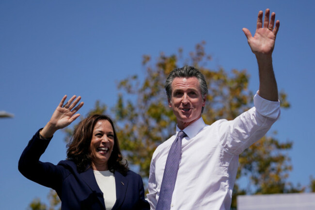 vice-president-kamala-harris-stands-on-stage-with-california-gov-gavin-newsom-at-the-conclusion-of-an-event-at-the-ibew-neca-joint-apprenticeship-training-center-in-san-leandro-calif-wednesday-se