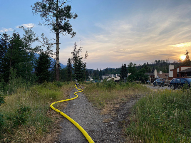 jasper-national-park-alberta-canada-25th-july-2024-water-hoses-are-being-used-to-help-protect-structures-in-jasper-national-park-wildfires-have-spread-through-jasper-national-park-causing-signi