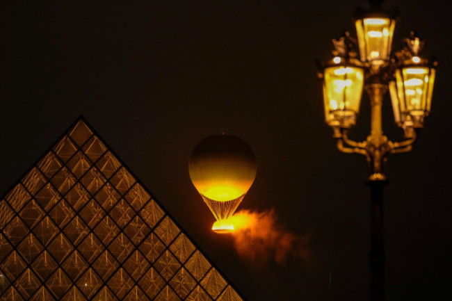 the-olympic-flame-rises-on-a-balloon-after-being-lit-in-paris-france-during-the-opening-ceremony-of-the-2024-summer-olympics-friday-july-26-2024-ap-photofrancisco-seco