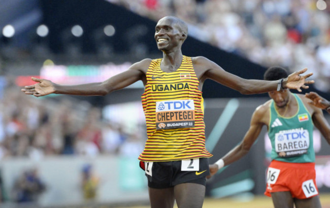 joshua-cheptegei-of-uganda-spreads-his-arms-as-he-crosses-the-finish-line-first-in-the-mens-10000-meters-during-the-world-athletics-championships-in-budapest-on-aug-20-2023-kyodokyodo-photo-v