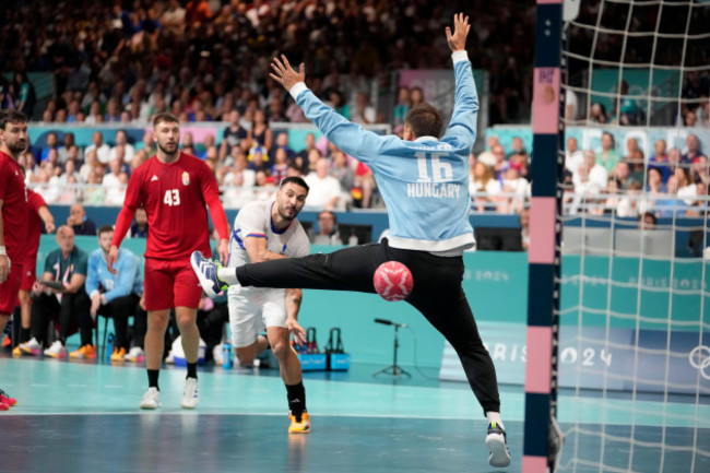 hugo-descat-of-france-attempts-to-score-past-goalkeeper-roland-mikler-of-hungary-during-a-mens-handball-match-at-the-2024-summer-olympics-sunday-aug-4-2024-in-paris-france-ap-photobrian