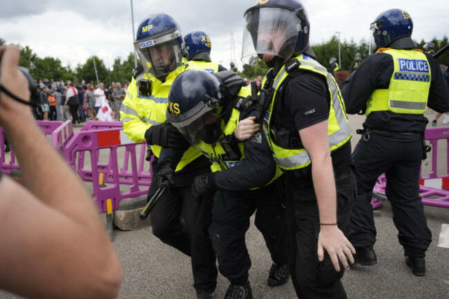 a-police-officers-is-injured-as-trouble-flares-during-an-anti-immigration-protest-outside-the-holiday-inn-express-in-rotherham-south-yorkshire-picture-date-sunday-august-4-2024