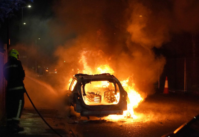 firefighters-tend-to-a-burning-police-car-burns-as-officers-are-deployed-on-the-streets-of-hartlepool-following-a-violent-protest-videos-on-social-media-show-a-crowd-of-people-in-a-street-with-one-s