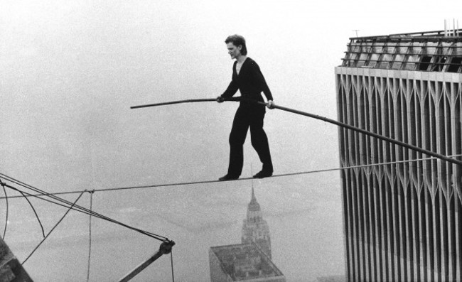 file-in-this-aug-7-1974-file-photo-philippe-petit-a-french-high-wire-artist-walks-across-a-tightrope-suspended-between-the-world-trade-centers-twin-towers-in-new-york-petit-and-his-companion