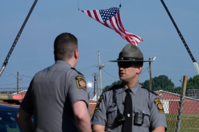 file-police-officers-stand-at-a-road-leading-to-the-site-of-the-trump-rally-where-access-is-closed-as-investigations-into-the-assassination-attempt-on-former-president-donald-trump-continue-in-bu