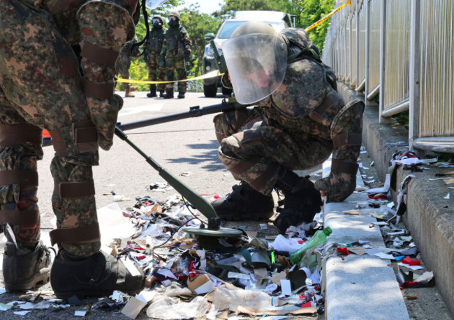 south-korean-soldiers-wearing-protective-gears-check-the-trash-from-a-balloon-presumably-sent-by-north-korea-in-incheon-south-korea-sunday-june-2-2024-im-sun-sukyonhap-via-ap