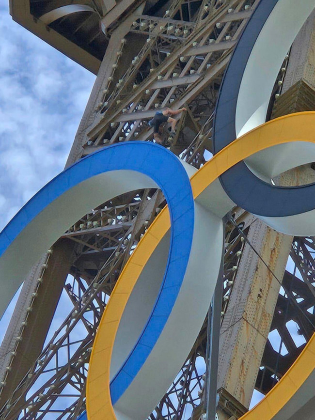 in-this-photo-provided-by-nicky-worlock-a-man-climbs-the-eiffel-tower-during-the-2024-summer-olympics-sunday-aug-11-2024-in-paris-france-nickey-worlock-via-ap