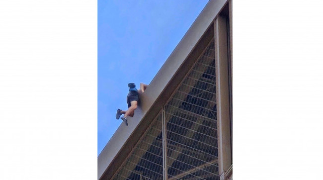 in-this-photo-provided-by-nickey-worlock-a-man-climbs-the-eiffel-tower-during-the-2024-summer-olympics-sunday-aug-11-2024-in-paris-france-nickey-worlock-via-ap