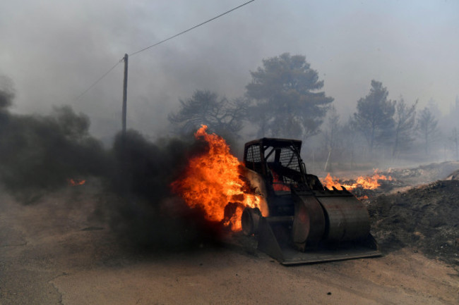 flames-burn-a-mini-excavator-during-a-fire-in-northern-athens-monday-aug-12-2024-as-hundreds-of-firefighters-tackle-a-major-wildfire-raging-out-of-control-on-fringes-of-greek-capital-ap-photom