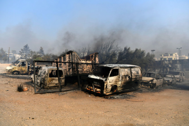 flames-burn-a-vehicle-at-a-business-during-a-fire-in-northern-athens-monday-aug-12-2024-as-hundreds-of-firefighters-tackle-a-major-wildfire-raging-out-of-control-on-fringes-of-greek-capital-ap