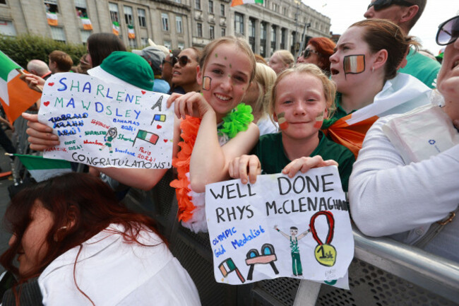 sisters-12-year-old-neasa-moloney-left-and-11-year-old-doireann-moloney-right-from-tipperary-display-homemade-posters-among-the-crowd-on-oconnell-street-in-dublin-ahead-of-a-homecoming-event-fo