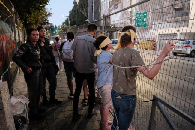 jerusalem-israel-15th-august-2024-activists-show-solidarity-with-israeli-hostages-in-gaza-by-tying-and-blindfolding-themselves-in-public-locations-with-similar-demonstrations-spontaneously-appear