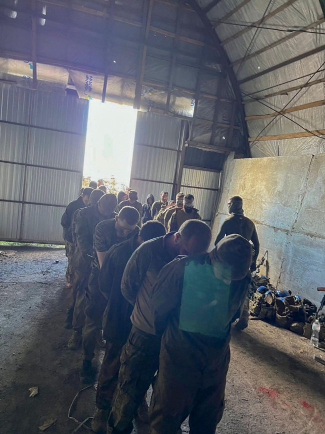 in-this-photo-provided-by-the-ukrainian-security-service-press-office-over-100-russian-prisoners-of-war-captured-by-a-security-service-special-unit-during-one-military-action-are-seen-in-a-shelter-in