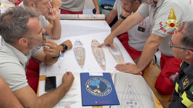 in-this-picture-released-by-the-italian-firefighters-tuesday-aug-20-2024-scuba-divers-study-a-map-of-the-sailing-yacht-bayesian-at-the-porticello-harbor-rescue-teams-and-divers-returned-to-the-si