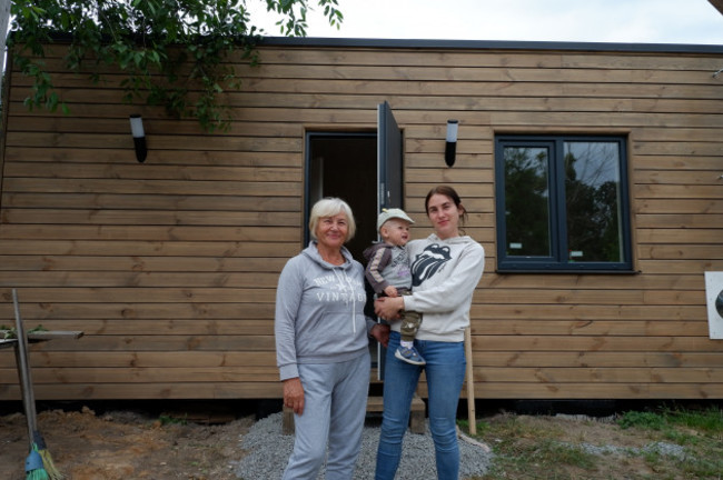 Maria (r) was sheltering with her one-month old son in the basement of a puppet theatre when she received a photo from a neighbour of her house in flames. (Pic UNHCR Ukraine)