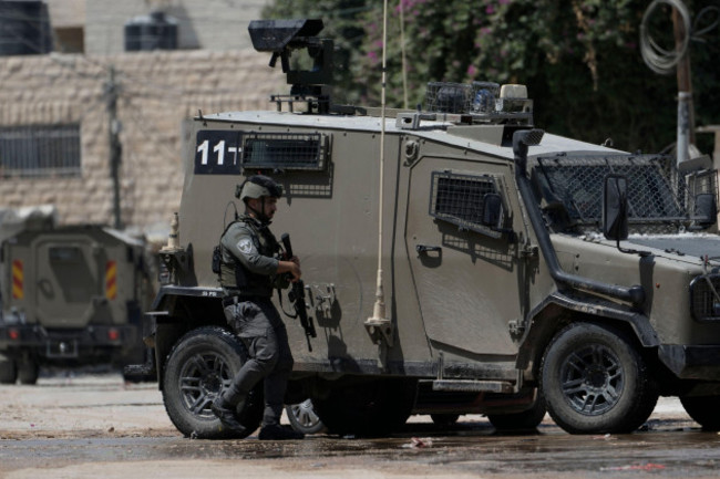 a-member-of-the-israeli-forces-walks-next-to-an-armoured-vehicle-during-a-military-operation-in-the-west-bank-city-of-jenin-wednesday-aug-28-2024-ap-photomajdi-mohammed