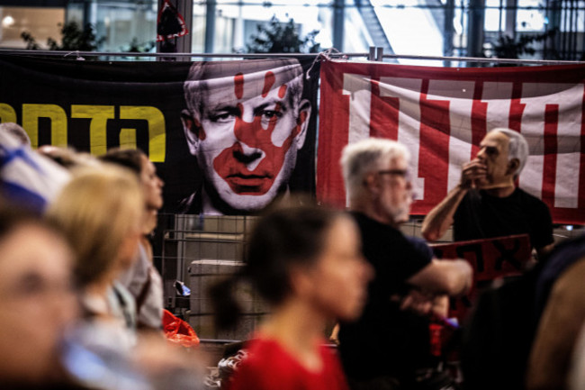 tel-aviv-israel-31st-aug-2024-protestors-walk-past-an-image-of-israeli-prime-minister-benjamin-netanyahu-during-a-protest-in-tel-aviv-saturday-aug-31-2024-israel-says-its-forces-have-recovered-th