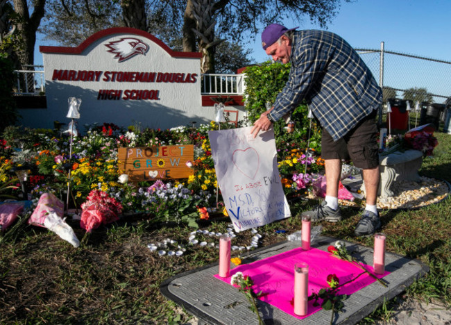 jack-jozefs-places-a-sign-at-a-memorial-outside-the-school-during-the-one-year-anniversary-of-the-shooting-death-of-17-at-majory-stoneman-douglas-high-school-thursday-feb-14-2019-in-parkland-fla