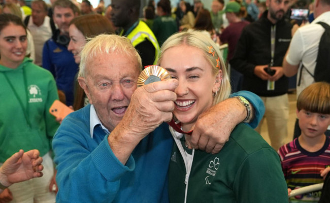 irelands-orla-comerford-with-her-grand-uncle-eamon-arriving-at-terminal-2-dublin-airport-after-competing-at-the-2024-paris-paralympic-summer-games-picture-date-monday-september-9-2024