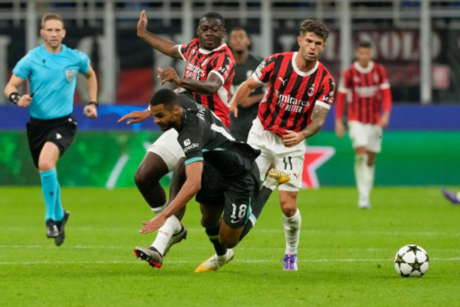 liverpools-cody-gakpo-front-is-challenged-by-ac-milans-youssouf-fofana-and-christian-pulisic-during-the-champions-league-opening-phase-soccer-match-between-ac-milan-and-liverpool-at-the-san-siro-s