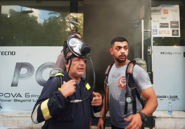 firefighters-stand-outside-a-damaged-mobile-shop-after-what-is-believed-to-be-the-result-of-a-walkie-talkies-exploding-inside-it-in-the-southern-port-city-of-sidon-lebanon-wednesday-sept-18-2024