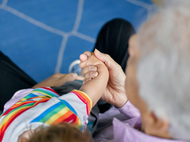 close-up-of-boy-and-grandfather-holding-hands