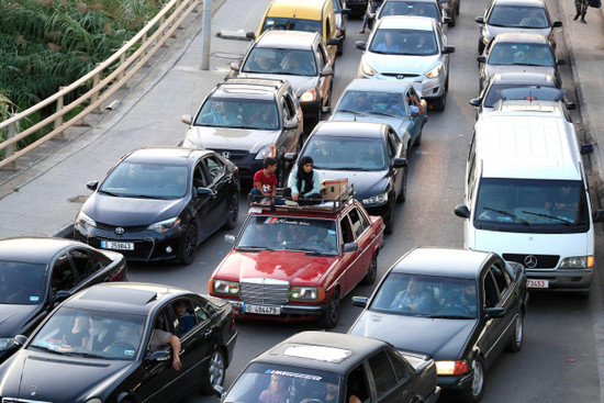 lebanese-citizens-who-fled-on-he-southern-villages-amid-ongoing-israeli-airstrikes-monday-sit-on-their-cars-at-a-highway-that-links-to-beirut-city-in-the-southern-port-city-of-sidon-lebanon-tuesda