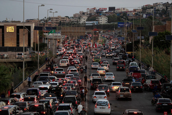 people-who-fled-the-southern-villages-amid-ongoing-israeli-airstrikes-monday-sit-in-their-cars-as-they-are-stuck-in-traffic-at-a-highway-that-links-to-beirut-city-in-the-southern-port-city-of-sidon