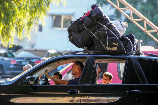 residents-who-fled-from-southern-villages-amid-ongoing-israeli-airstrikes-monday-drive-with-their-belongings-on-top-of-their-car-in-beirut-lebanon-tuesday-sept-24-2024-ap-photohassan-ammar