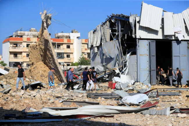 people-gather-at-the-site-of-an-israeli-airstrike-that-hit-a-hangar-in-the-southern-town-of-jiyeh-lebanon-wednesday-sept-25-2024-ap-photomohammed-zaatari