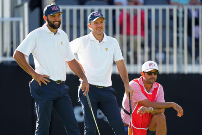 united-states-team-members-scottie-scheffler-left-and-russell-henley-center-laugh-on-the-13th-hole-during-their-first-round-four-ball-match-at-the-presidents-cup-golf-tournament-at-the-royal-montr