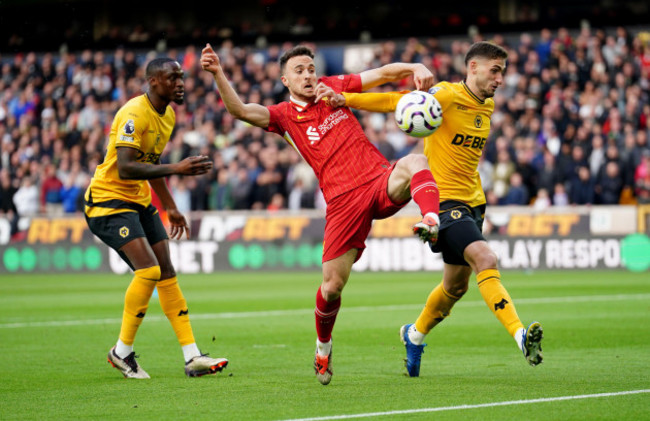 liverpools-diogo-jota-centre-is-challenged-by-wolverhampton-wanderers-santiago-bueno-right-during-the-premier-league-match-at-molineux-stadium-wolverhampton-picture-date-saturday-september-28