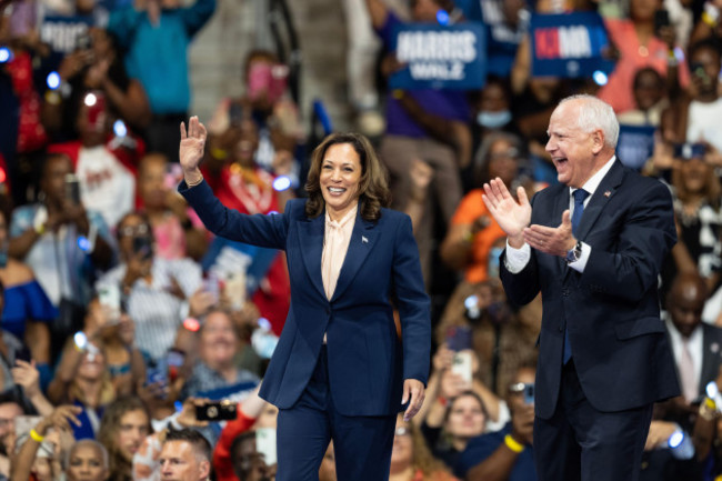 vice-president-kamala-harris-and-governor-of-minnesota-tim-walz-enter-the-stage-at-the-rally-in-liacouras-center-at-temple-university-in-philadelphia-pa-on-august-6-2024