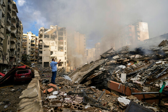 a-man-documents-the-damaged-buildings-at-the-site-of-an-israeli-airstrike-in-beiruts-southern-suburb-lebanon-tuesday-oct-1-2024-ap-photohassan-ammar